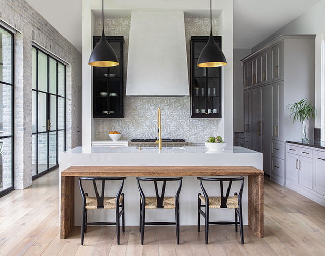 Carrara marble kitchen with luxury range and custom pot holder detail in Houston, TX